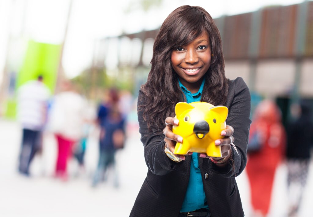 Black woman holding a piggy bank